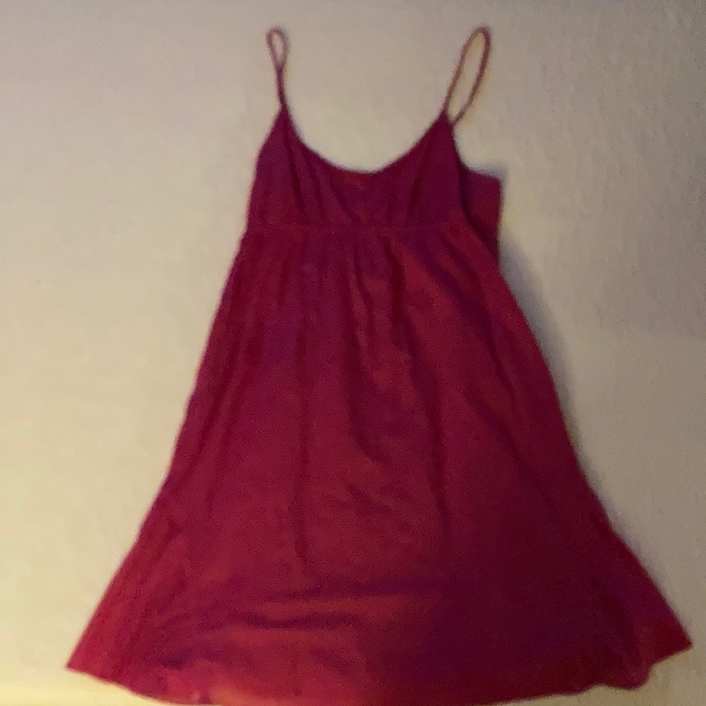 A bright pink dress that has white dots.